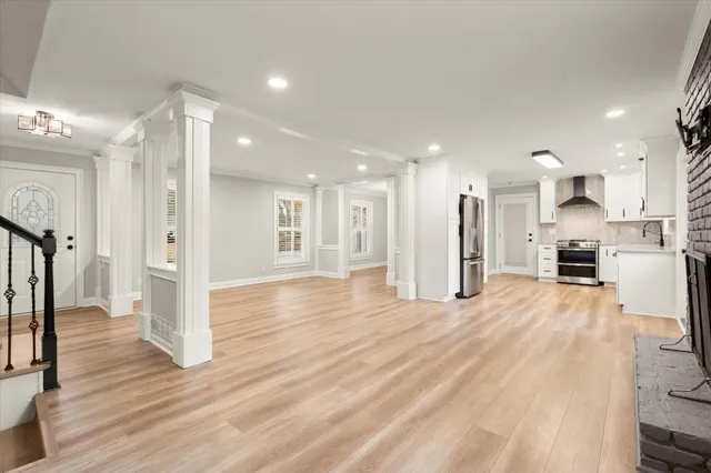 a view of a kitchen with refrigerator and wooden floor