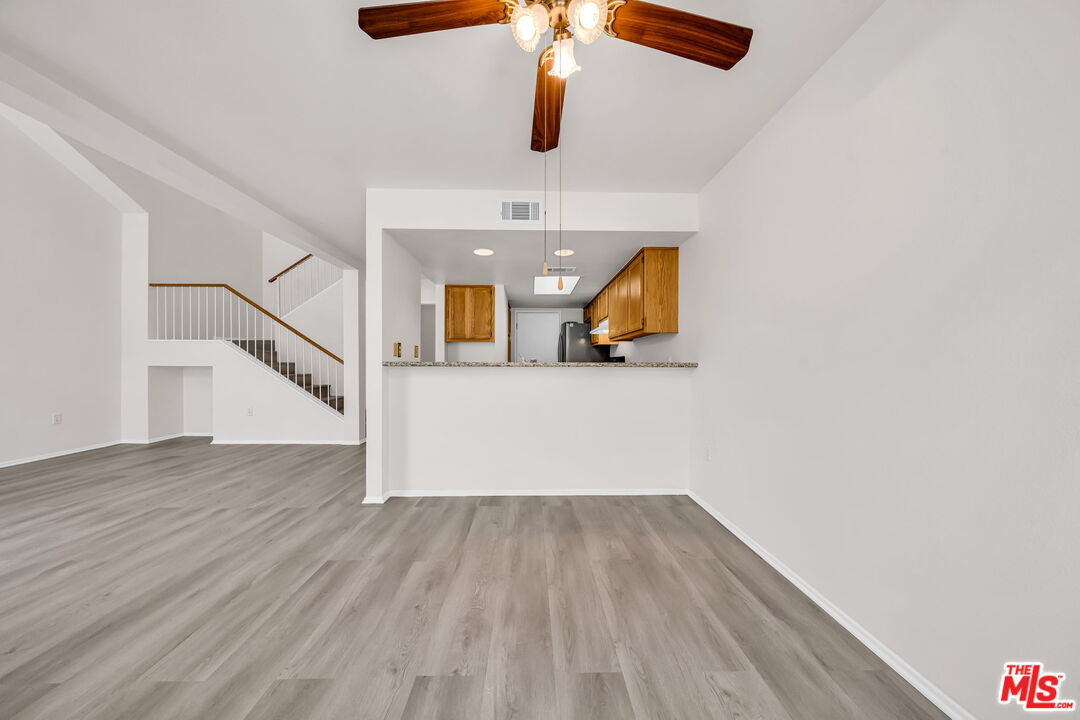 820 West Compton Boulevard, Unit 17 Compton, CA 90220 - Photo 12 of 50 a view of a livingroom with wooden floor and a ceiling fan