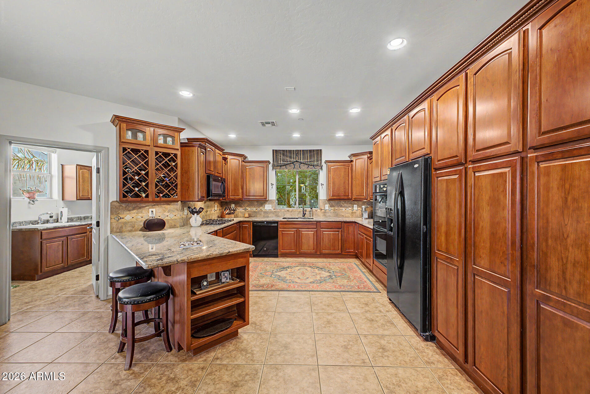 2996 East Agritopia Loop North Gilbert, AZ 85296 - Photo 12 of 73 a large kitchen with a large counter top space and stainless steel appliances