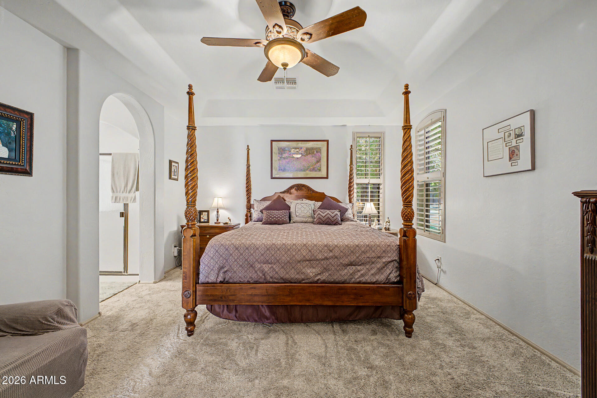 2996 East Agritopia Loop North Gilbert, AZ 85296 - Photo 14 of 73 a spacious bedroom with a bed and a chandelier