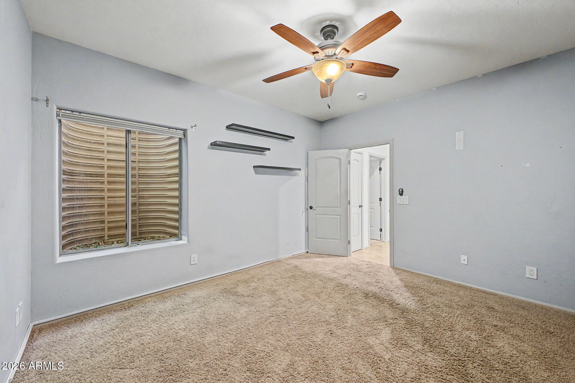 2996 East Agritopia Loop North Gilbert, AZ 85296 - Photo 22 of 73 an empty room with a window and a ceiling fan