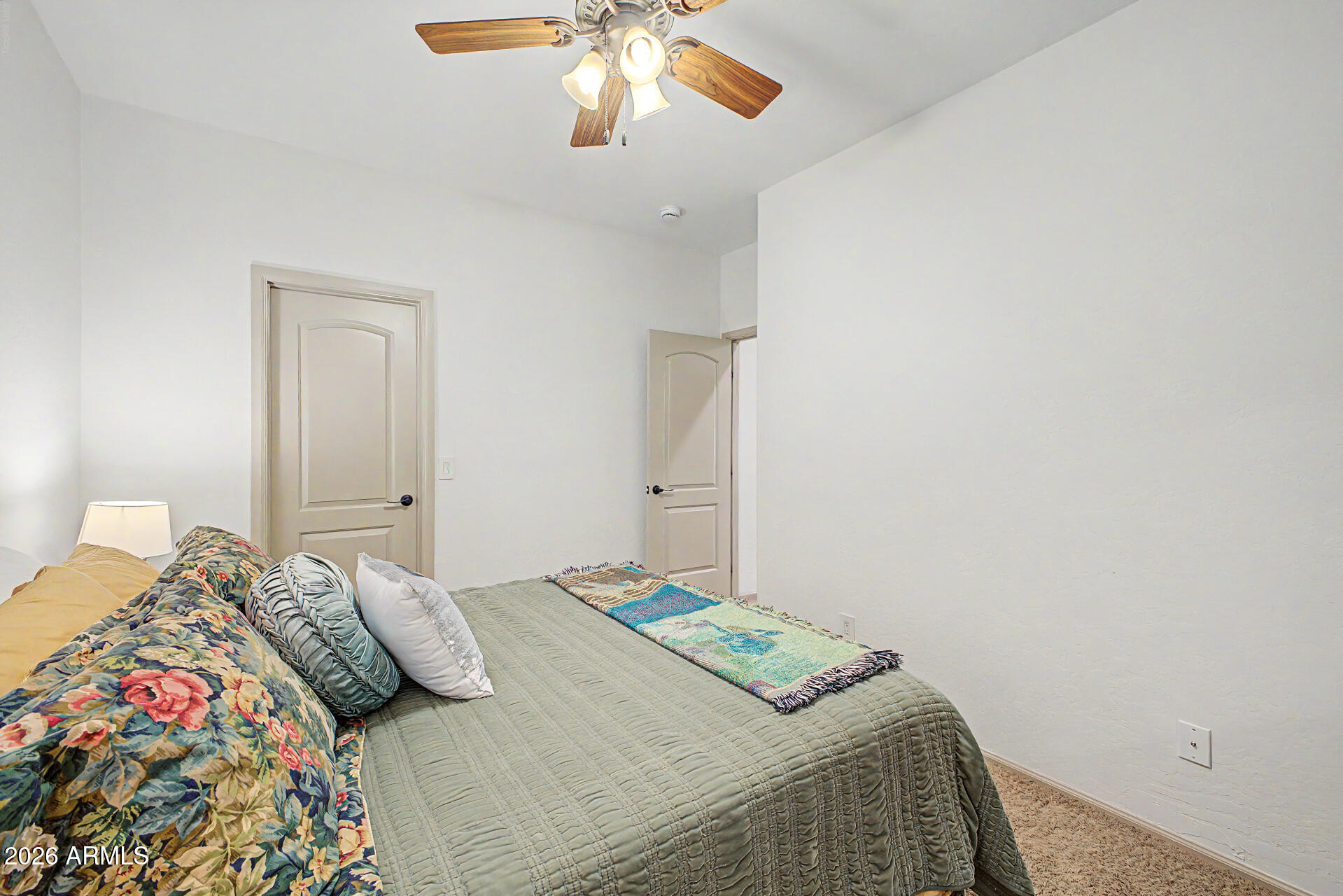 2996 East Agritopia Loop North Gilbert, AZ 85296 - Photo 25 of 73 a bedroom with a bed and a chandelier