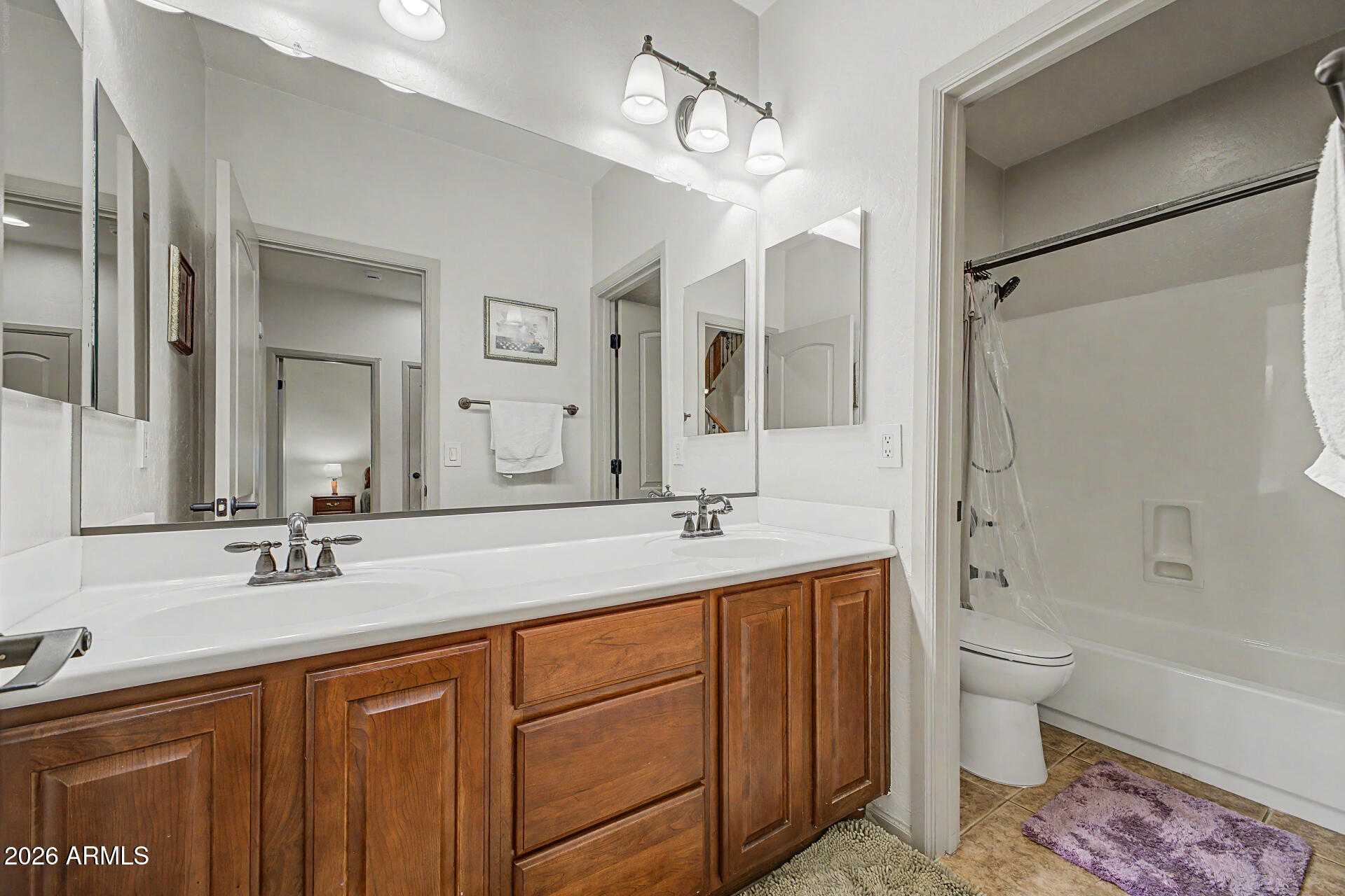 2996 East Agritopia Loop North Gilbert, AZ 85296 - Photo 26 of 73 a bathroom with a double vanity sink toilet mirror and bathtub