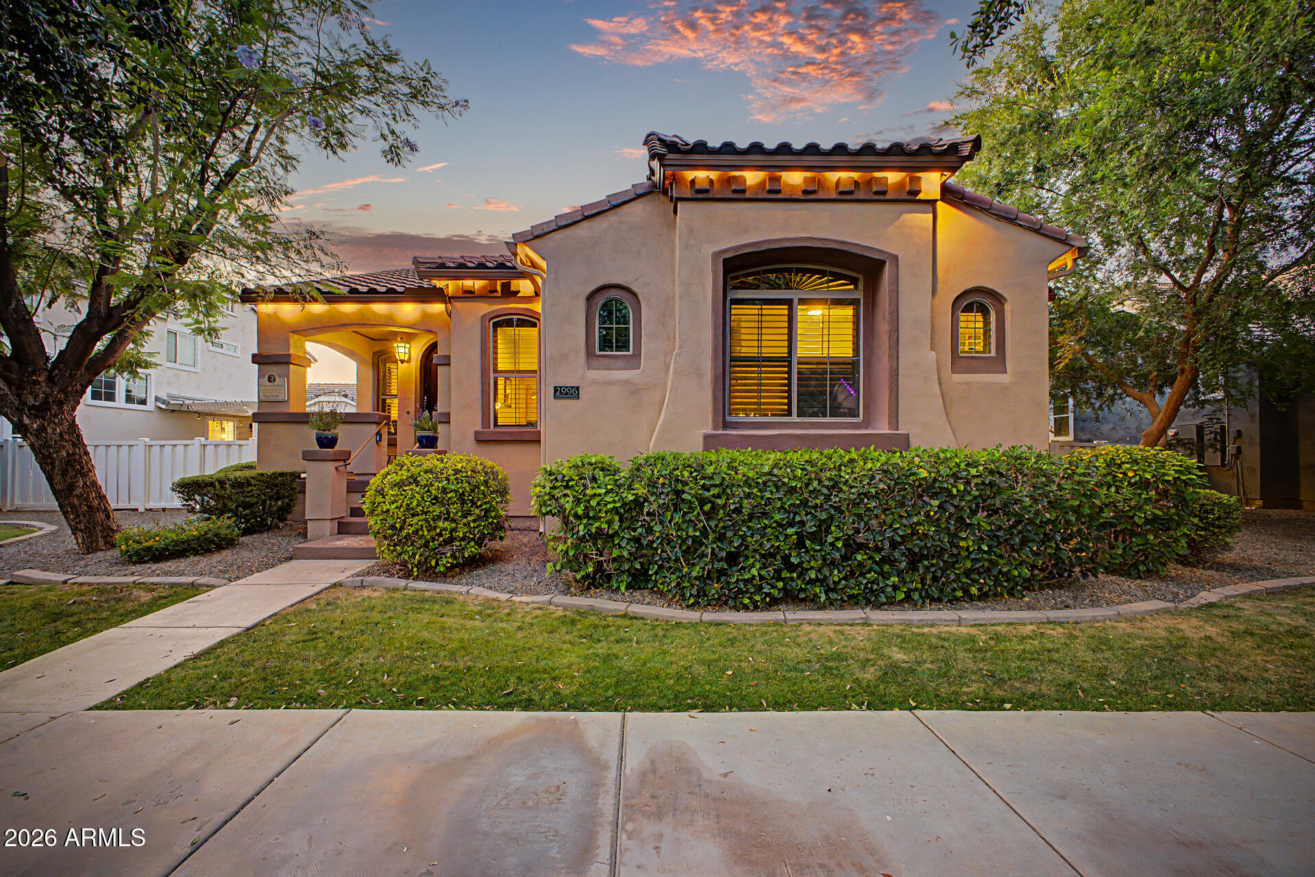 2996 East Agritopia Loop North Gilbert, AZ 85296 - Photo 2 of 73 a front view of a house with a yard