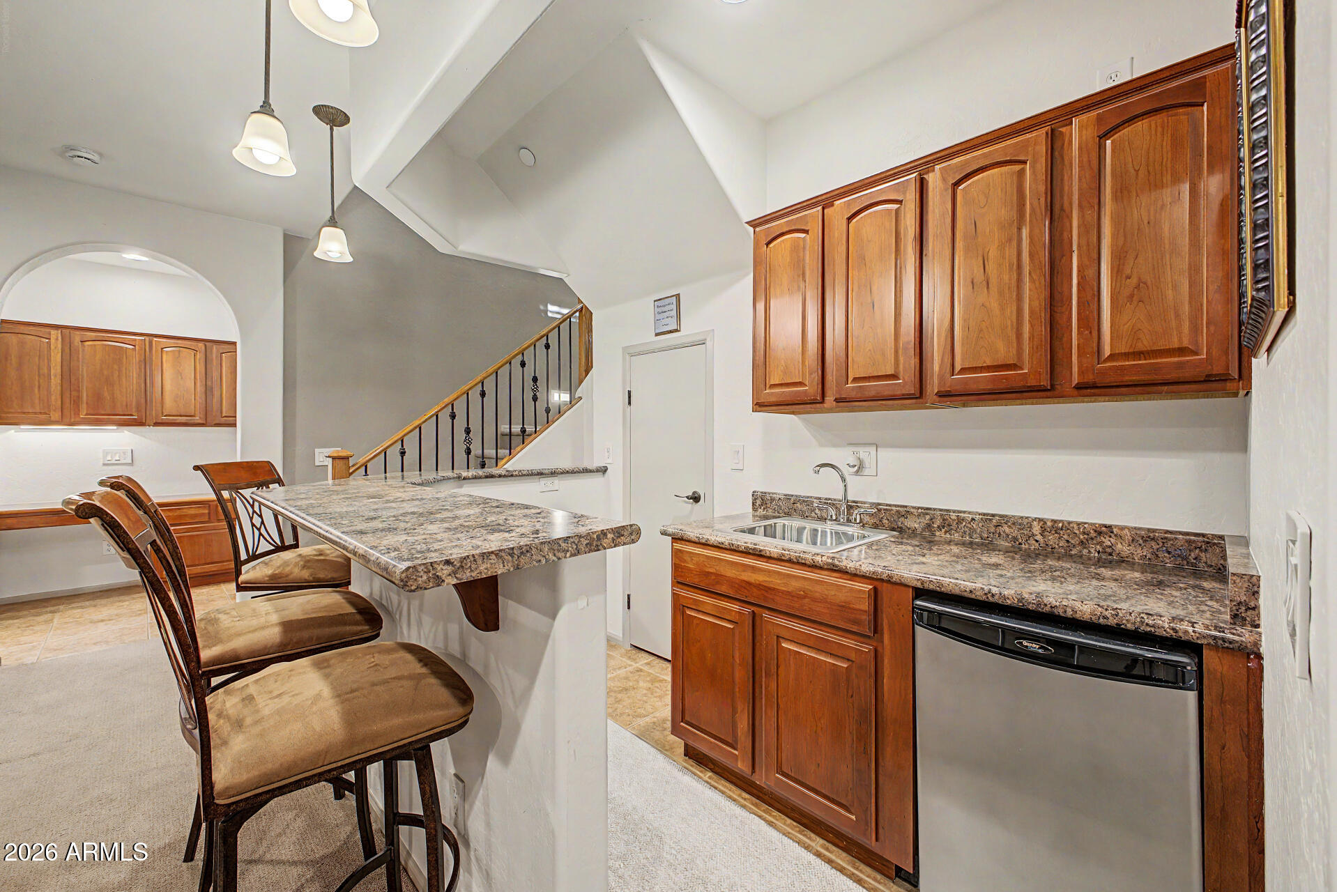 2996 East Agritopia Loop North Gilbert, AZ 85296 - Photo 28 of 73 a kitchen with stainless steel appliances granite countertop a stove a sink dishwasher and a refrigerator with wooden cabinets