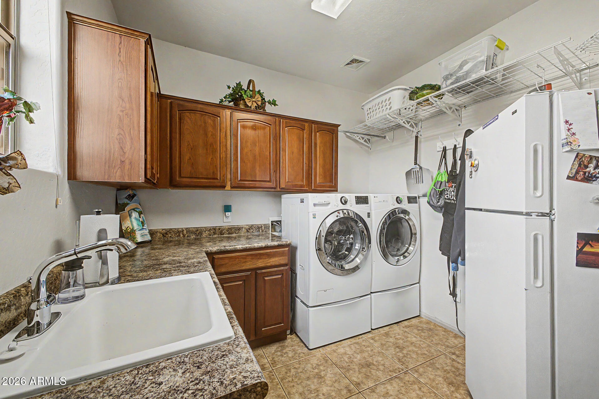 2996 East Agritopia Loop North Gilbert, AZ 85296 - Photo 47 of 73 a utility room with stainless steel appliances granite countertop a sink a stove a refrigerator and cabinets