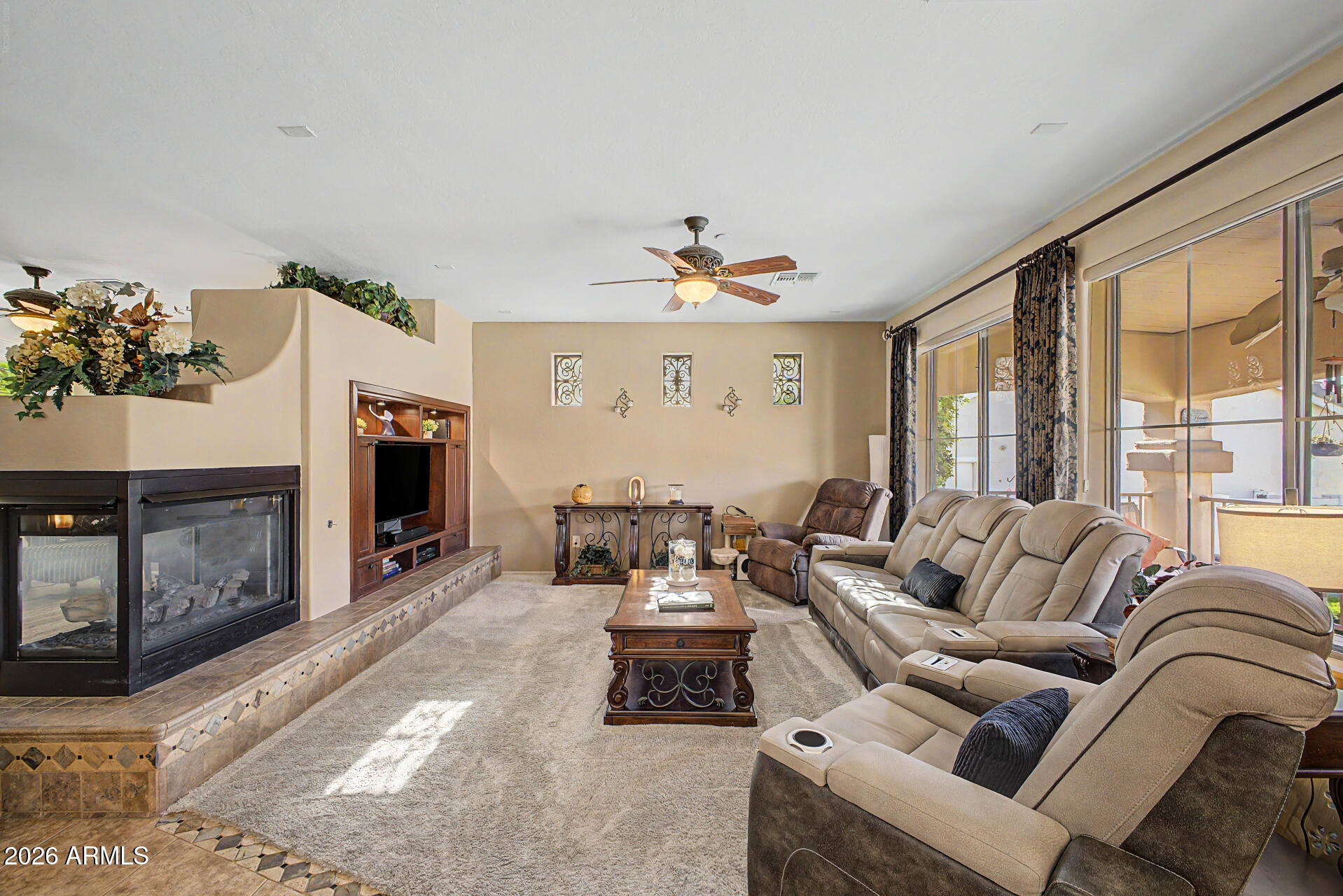 2996 East Agritopia Loop North Gilbert, AZ 85296 - Photo 7 of 73 a living room with furniture large window and a fireplace