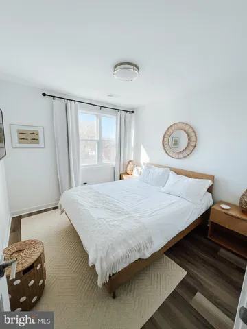 a bed sitting in a spacious bedroom next to a window