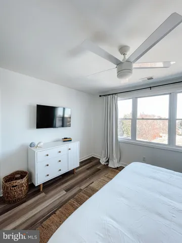 a bedroom with a bed and flat screen tv