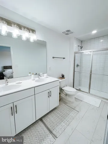 a spacious bathroom with a double vanity sink mirror and toilet
