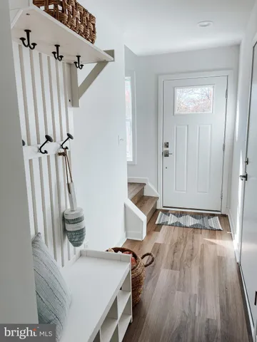 a view of an entryway with wooden floor