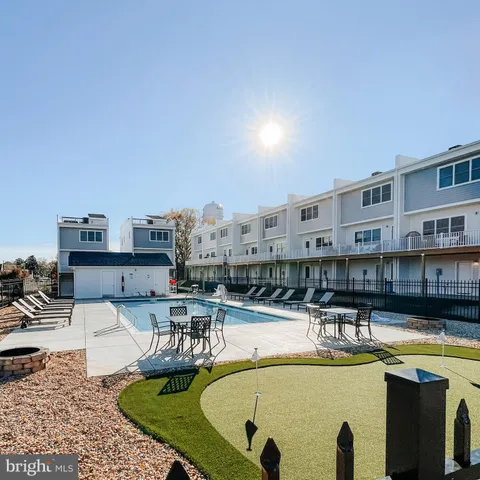 a view of a swimming pool with outdoor seating