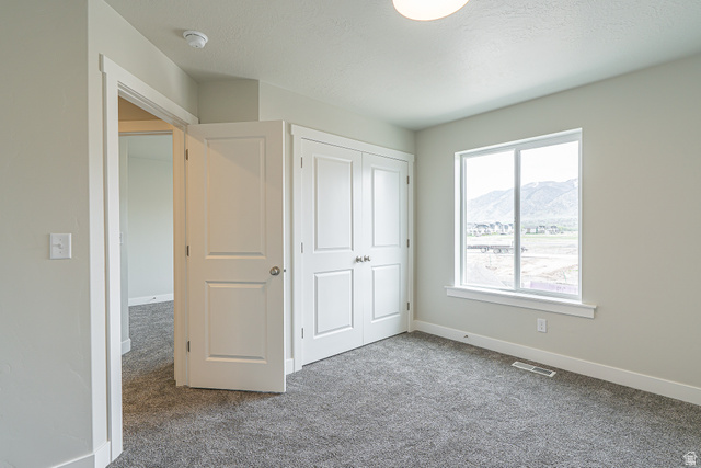 2249 South 1090 West, Unit 76 Nibley, UT 84321 - Photo 10 of 19 Room featuring neutral-toned walls, grey carpet, and a white-framed window