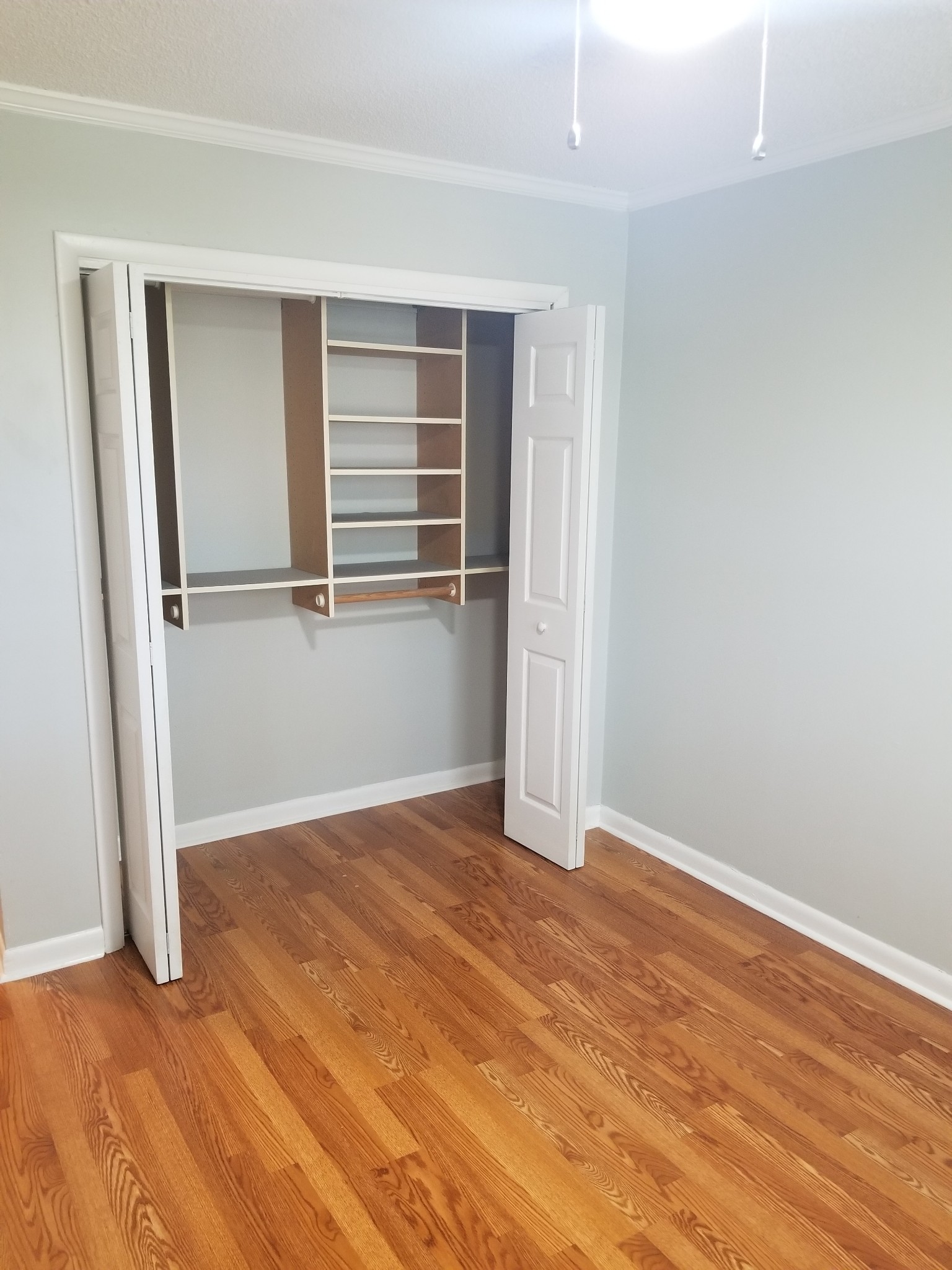 323 Forest Park Road, Unit 516 Madison, TN 37115 - Photo 6 of 12 an empty room with wooden floor and windows