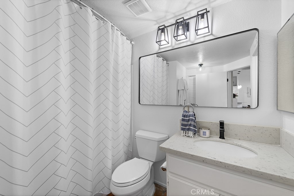 12 Bright Water Drive Dana Point, CA 92629 - Photo 14 of 24 a bathroom with a toilet a sink and mirror