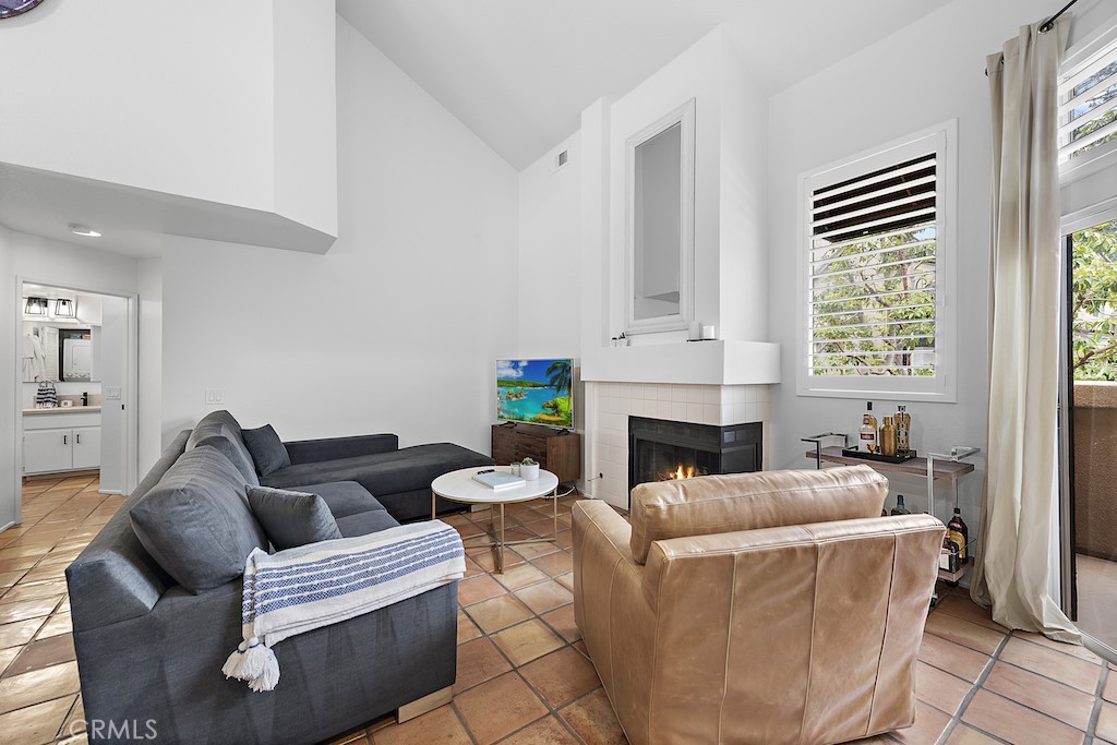 12 Bright Water Drive Dana Point, CA 92629 - Photo 5 of 24 a living room with furniture a fireplace and a large window