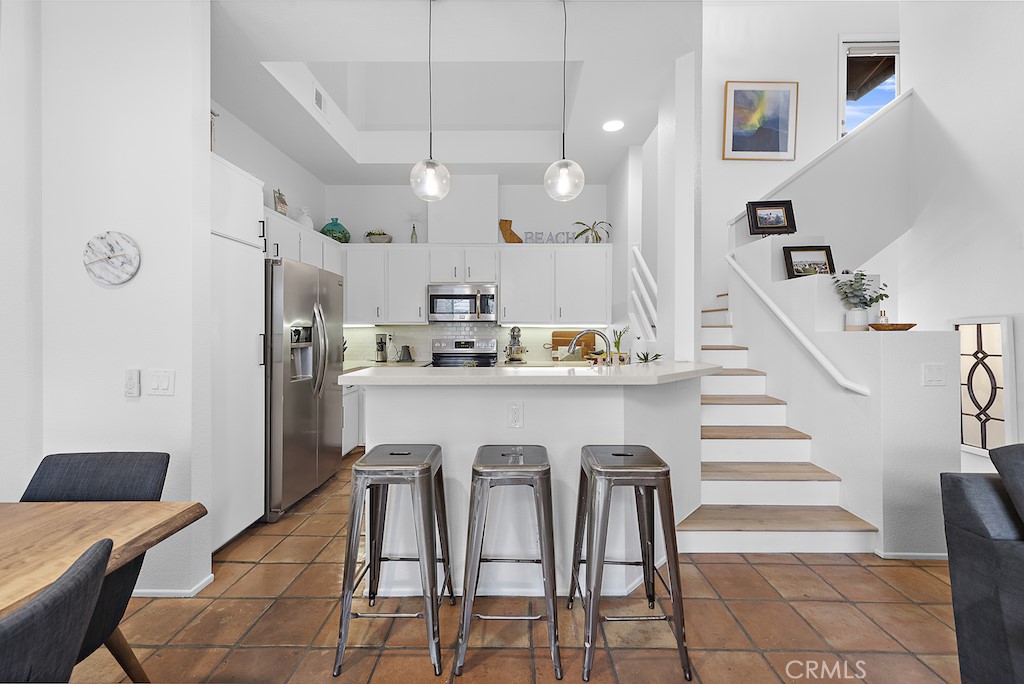 12 Bright Water Drive Dana Point, CA 92629 - Photo 6 of 24 a kitchen with stainless steel appliances kitchen island granite countertop a refrigerator and a stove top oven with a dishwasher