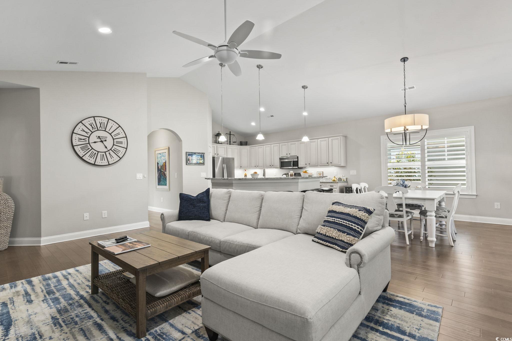 636 Elmwood Circle Murrells Inlet, SC 29576 - Photo 10 of 36 Living room featuring arched walkways, dark wood-type flooring, a ceiling fan, recessed lighting, and high vaulted ceiling