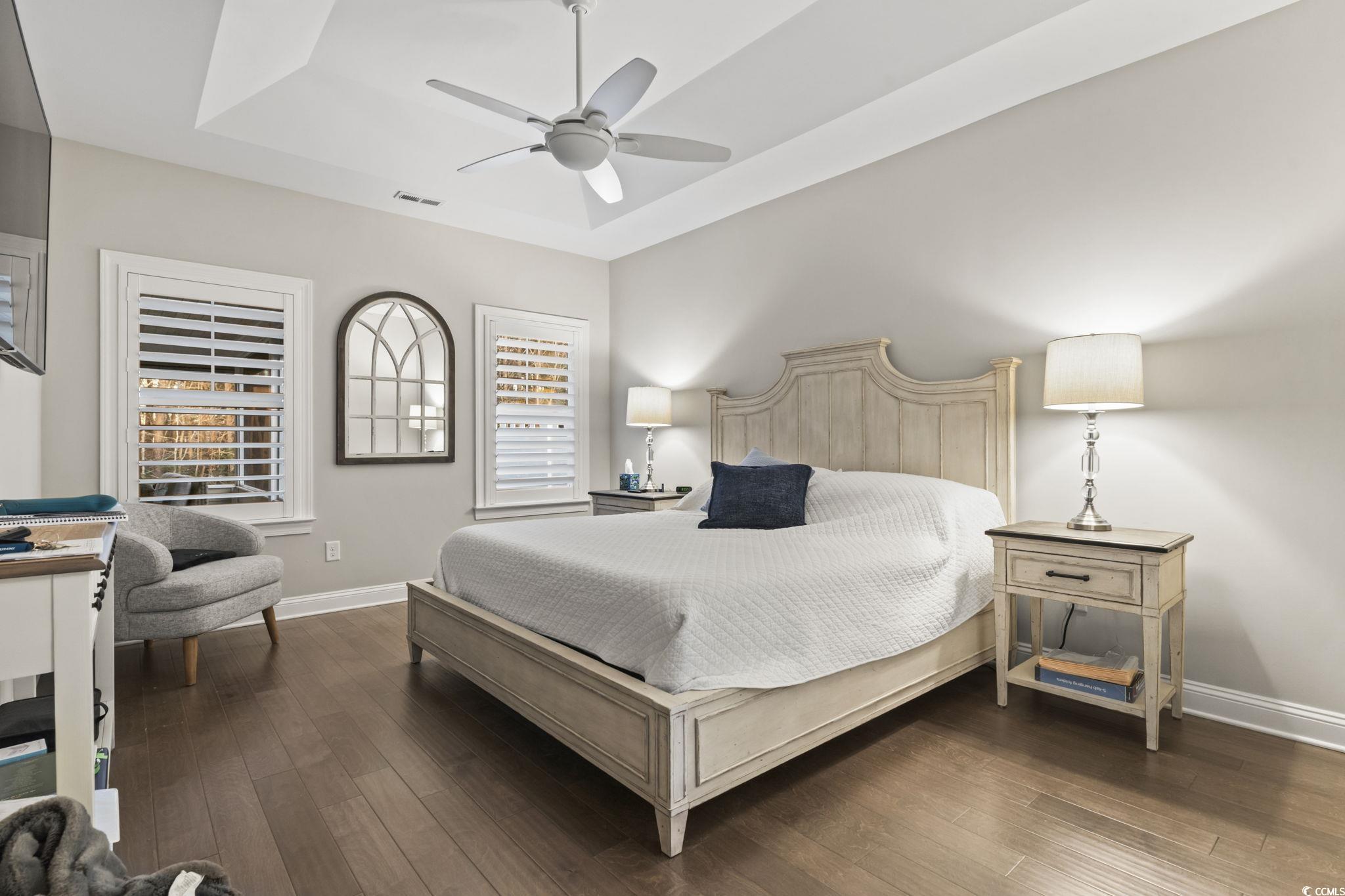 636 Elmwood Circle Murrells Inlet, SC 29576 - Photo 14 of 36 Bedroom with a raised ceiling, dark wood-style floors, and a ceiling fan