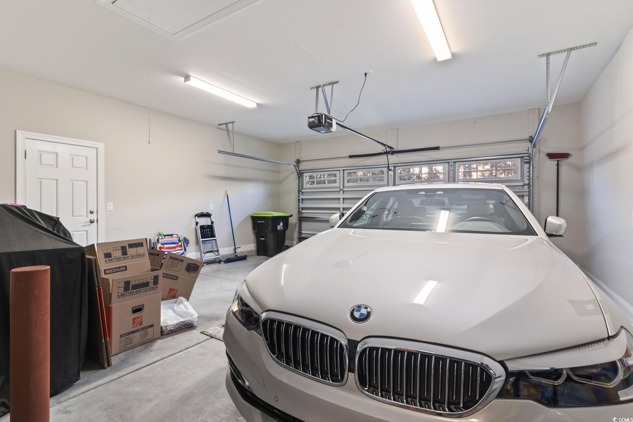 636 Elmwood Circle Murrells Inlet, SC 29576 - Photo 22 of 36 Garage featuring a garage door opener