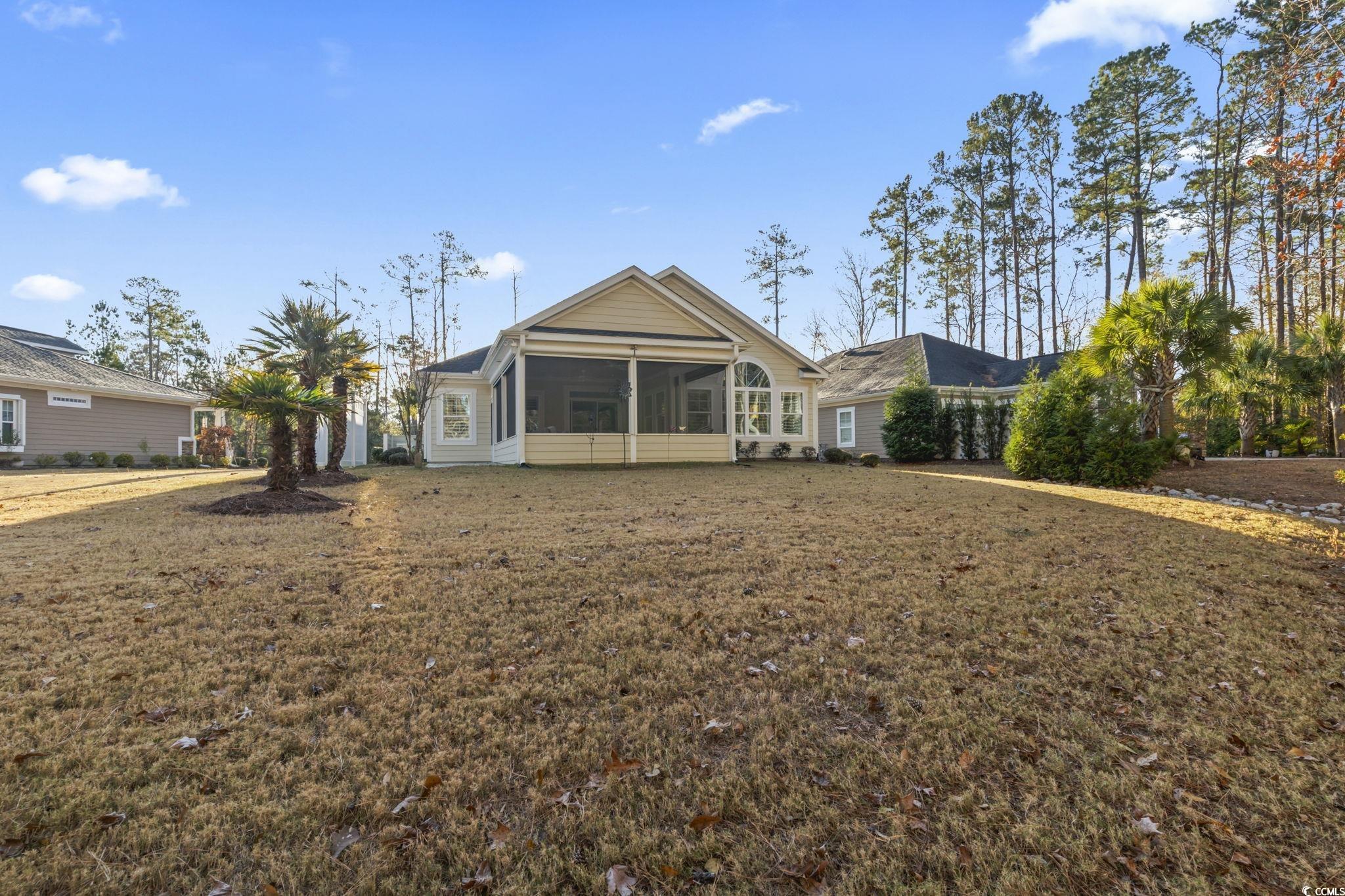 636 Elmwood Circle Murrells Inlet, SC 29576 - Photo 26 of 36 Rear view of property featuring a sunroom and a lawn