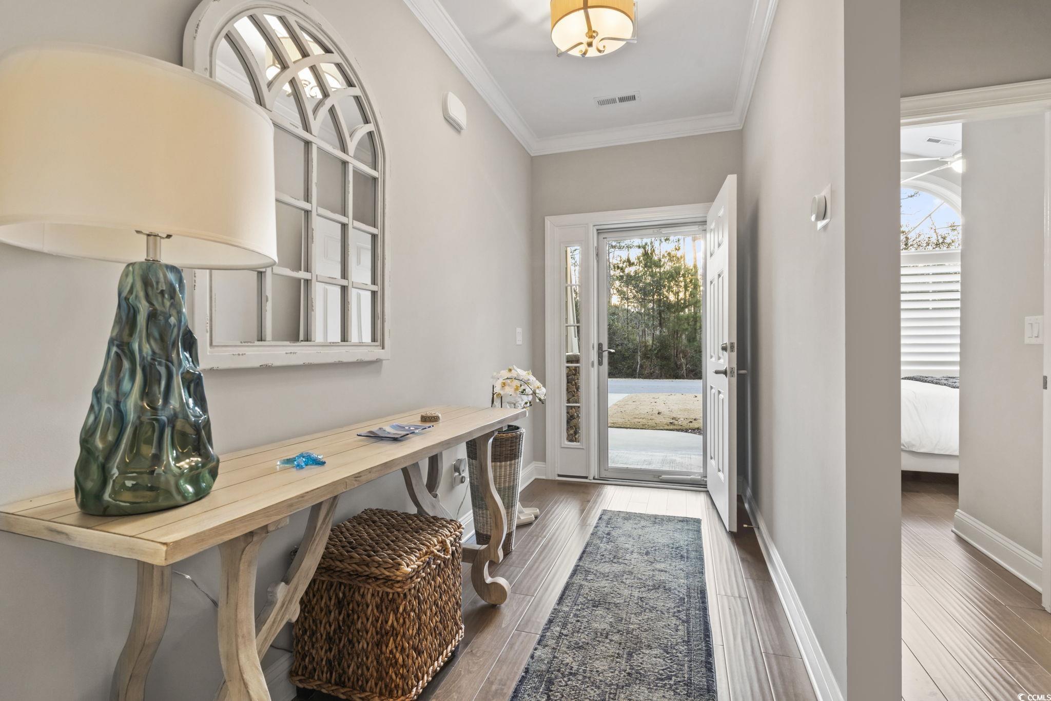 636 Elmwood Circle Murrells Inlet, SC 29576 - Photo 4 of 36 Doorway to outside with ornamental molding and wood finished floors