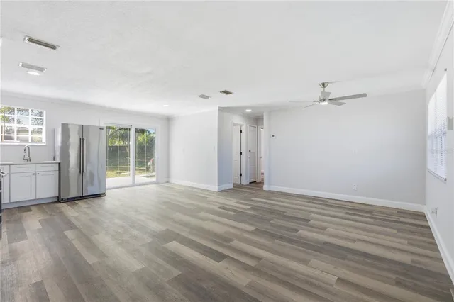 wooden floor in an empty room with a window