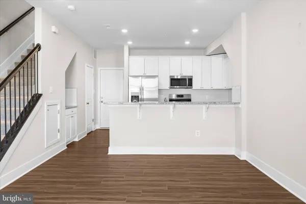 a view of wooden floor and windows in a room