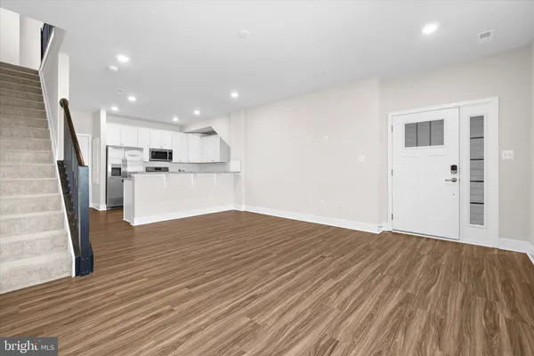 a kitchen with a sink window and stainless steel appliances