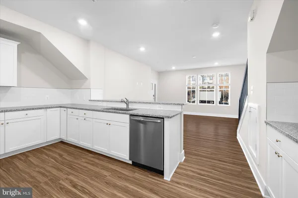 a kitchen with stainless steel appliances granite countertop a stove a refrigerator and a microwave