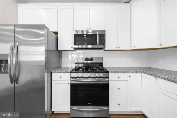 a kitchen with sink and cabinets