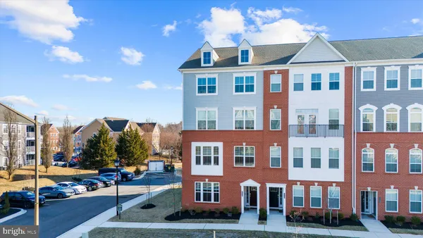 a front view of a residential apartment building with a yard