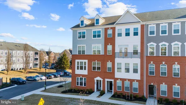 a front view of a residential apartment building with a yard