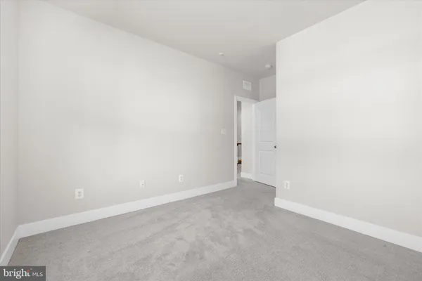 a view of a livingroom with an empty space and window