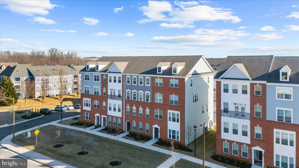 a front view of a residential apartment building with a yard