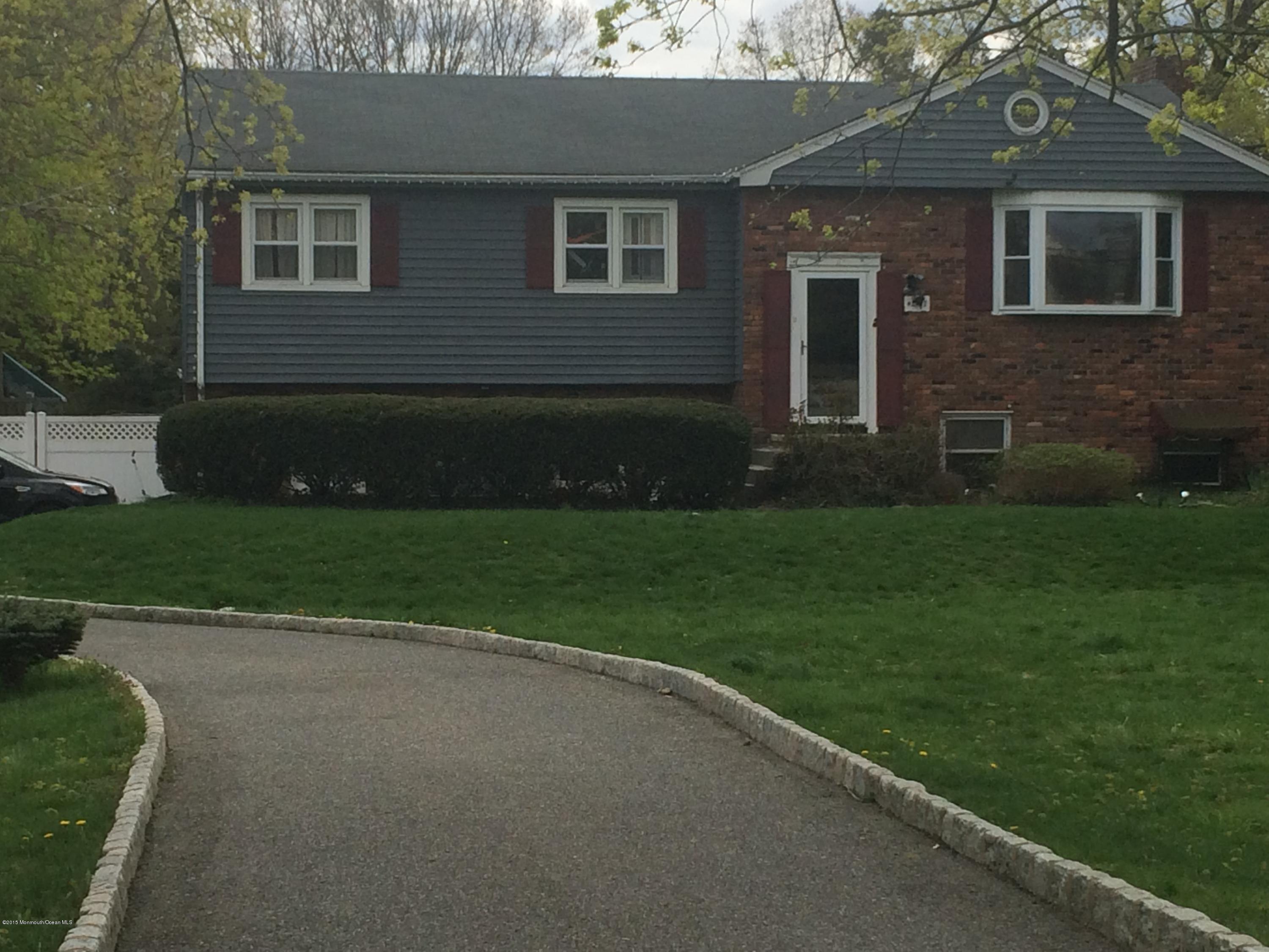 2707 Woolley Road Wall, NJ 07719 - Photo 1 of 3 a front view of a house with garden