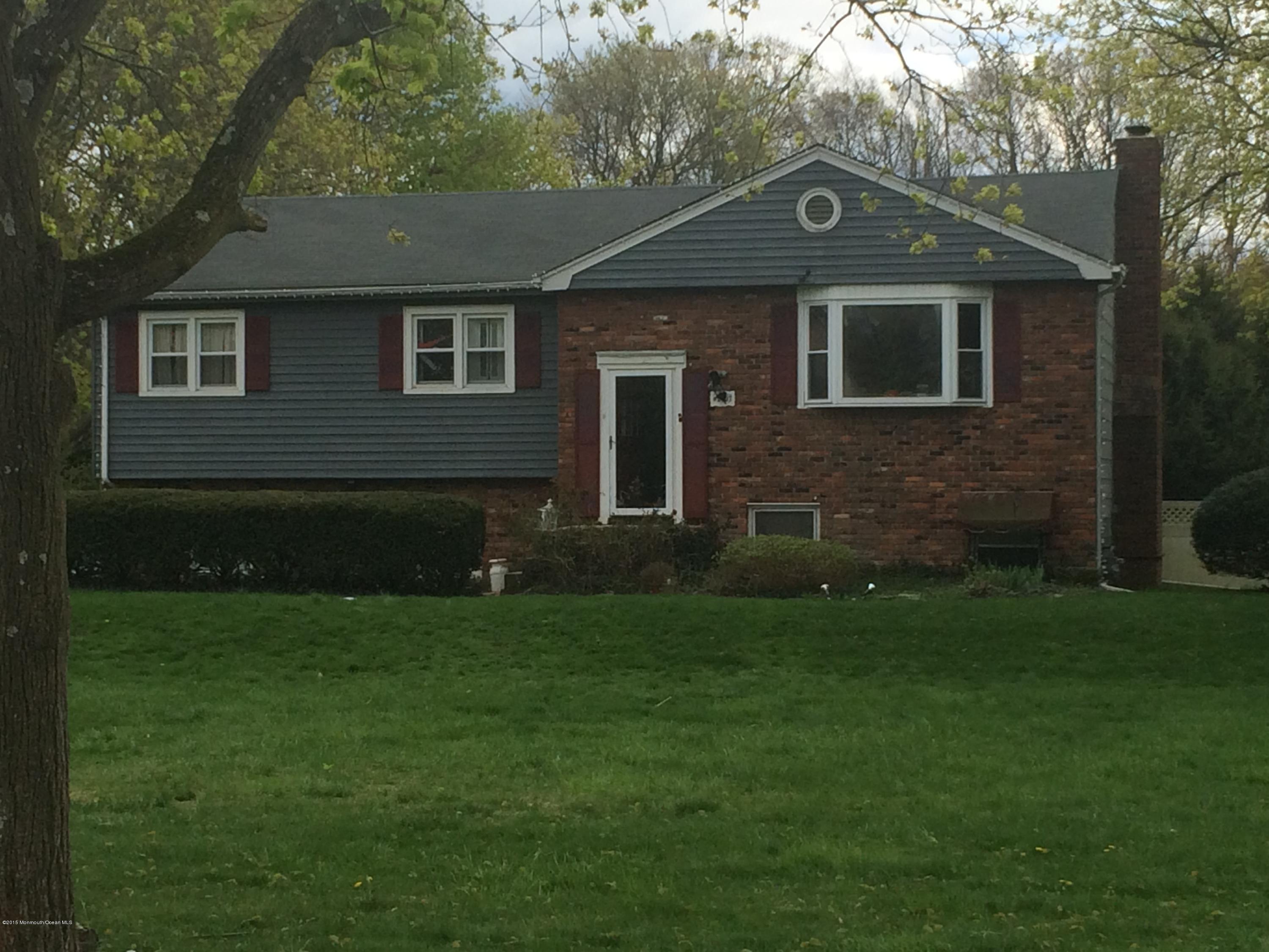 2707 Woolley Road Wall, NJ 07719 - Photo 2 of 3 a front view of a house with a yard