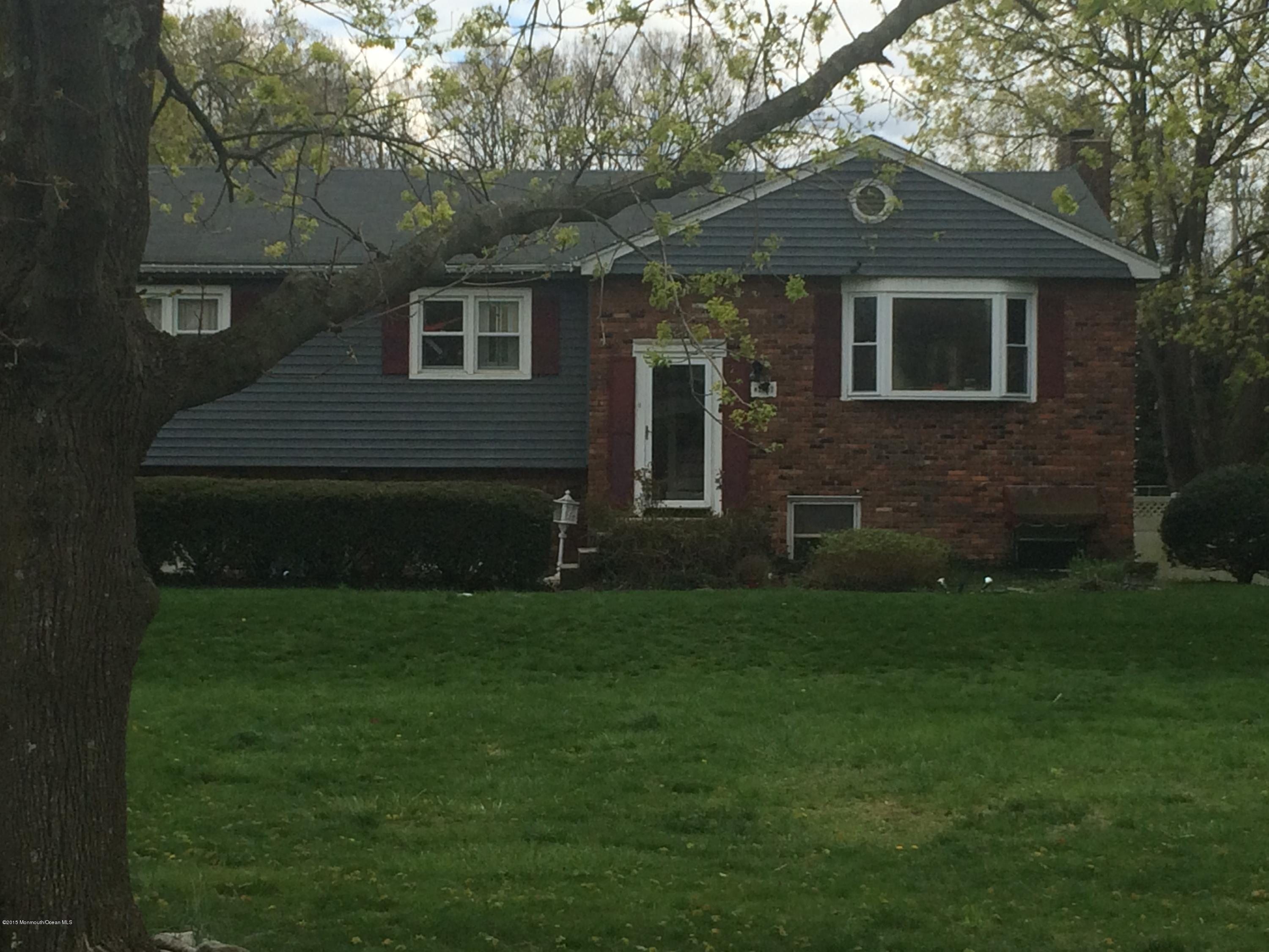 2707 Woolley Road Wall, NJ 07719 - Photo 3 of 3 a front view of a house with a garden