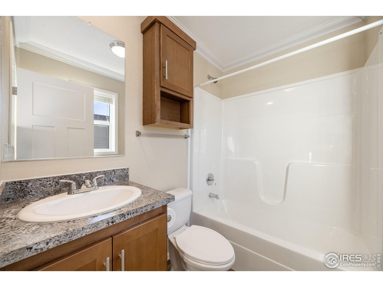 830 1st Street, Unit 16 Pierce, CO 80650 - Photo 13 of 15 a bathroom with a granite countertop sink toilet and shower