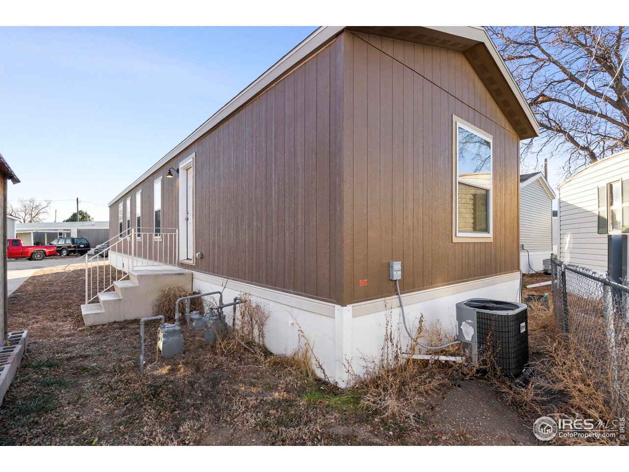830 1st Street, Unit 16 Pierce, CO 80650 - Photo 15 of 15 a backyard of a house with table and chairs
