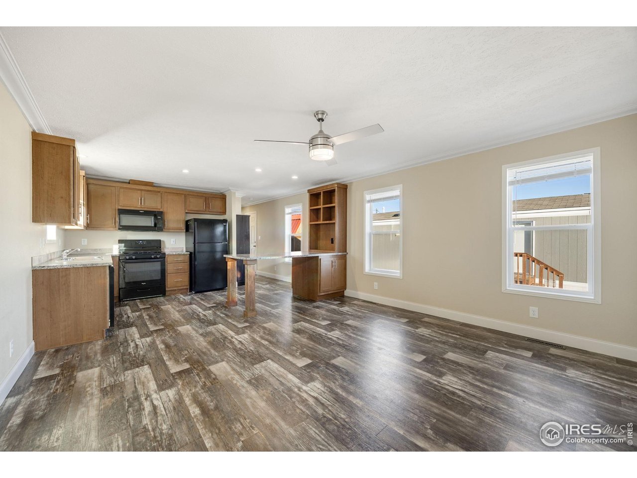 830 1st Street, Unit 16 Pierce, CO 80650 - Photo 3 of 15 a view of kitchen with a sink dishwasher stove and refrigerator with wooden floor
