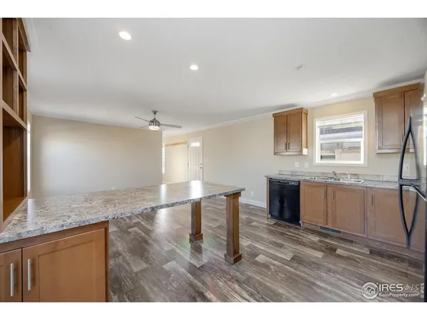 a kitchen with granite countertop a stove a sink and a microwave