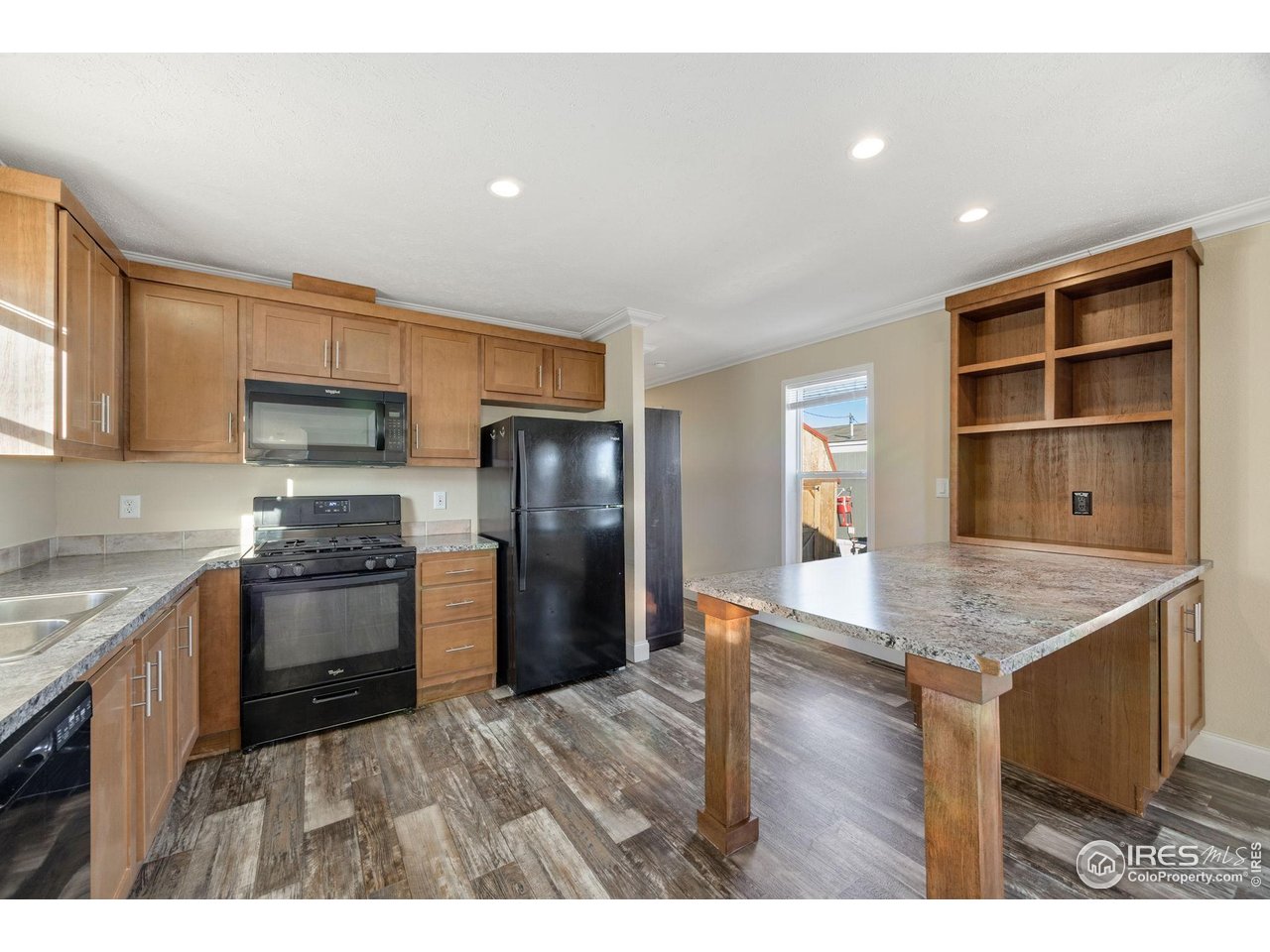 830 1st Street, Unit 16 Pierce, CO 80650 - Photo 6 of 15 a kitchen with stainless steel appliances granite countertop a sink stove and refrigerator