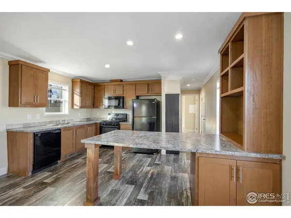 a kitchen with refrigerator and cabinets