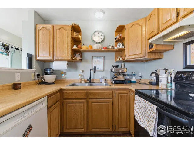 a kitchen with cabinets and clock