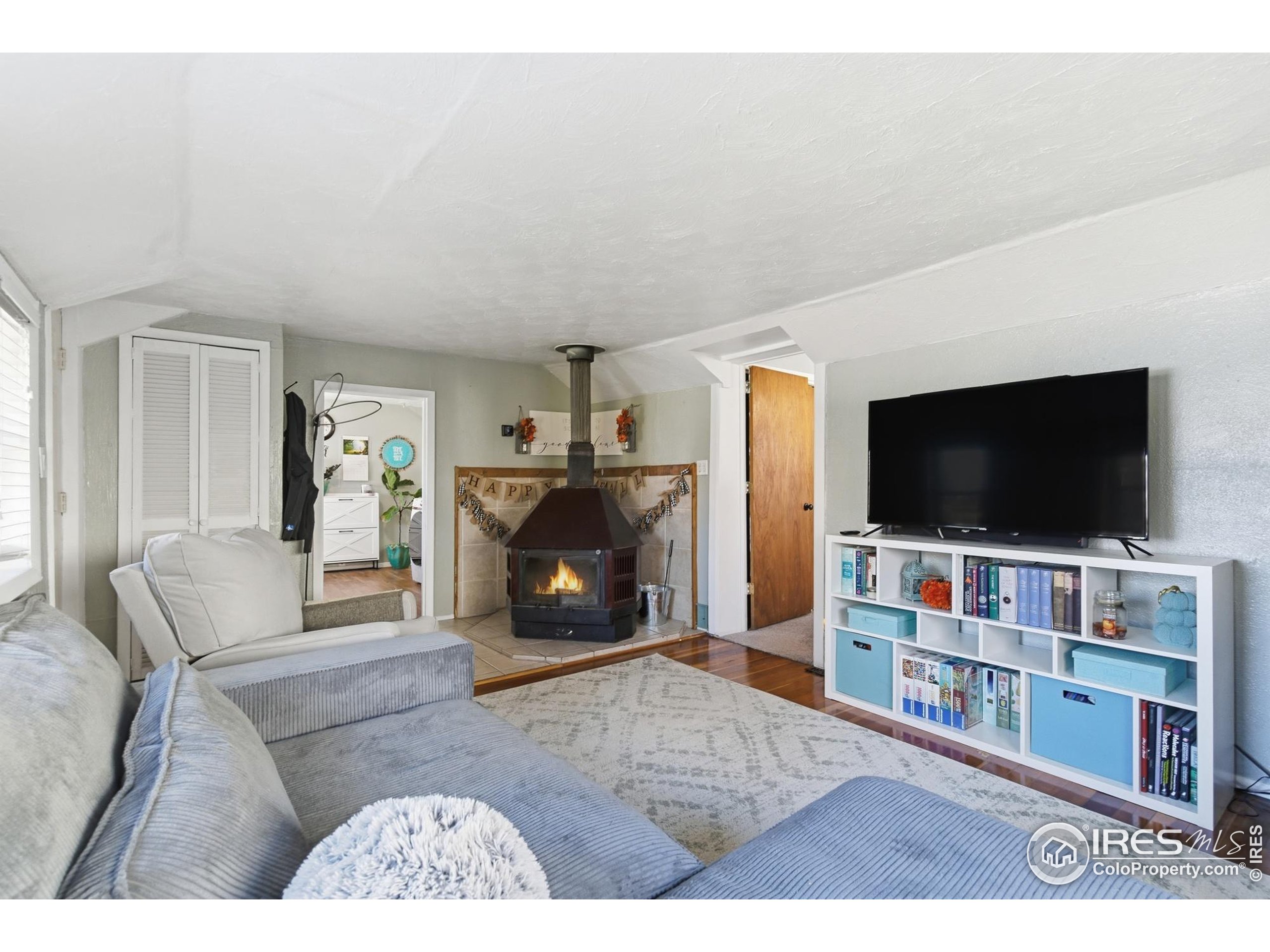 7905 3rd Street Wellington, CO 80549 - Photo 3 of 25 a living room with furniture and a flat screen tv