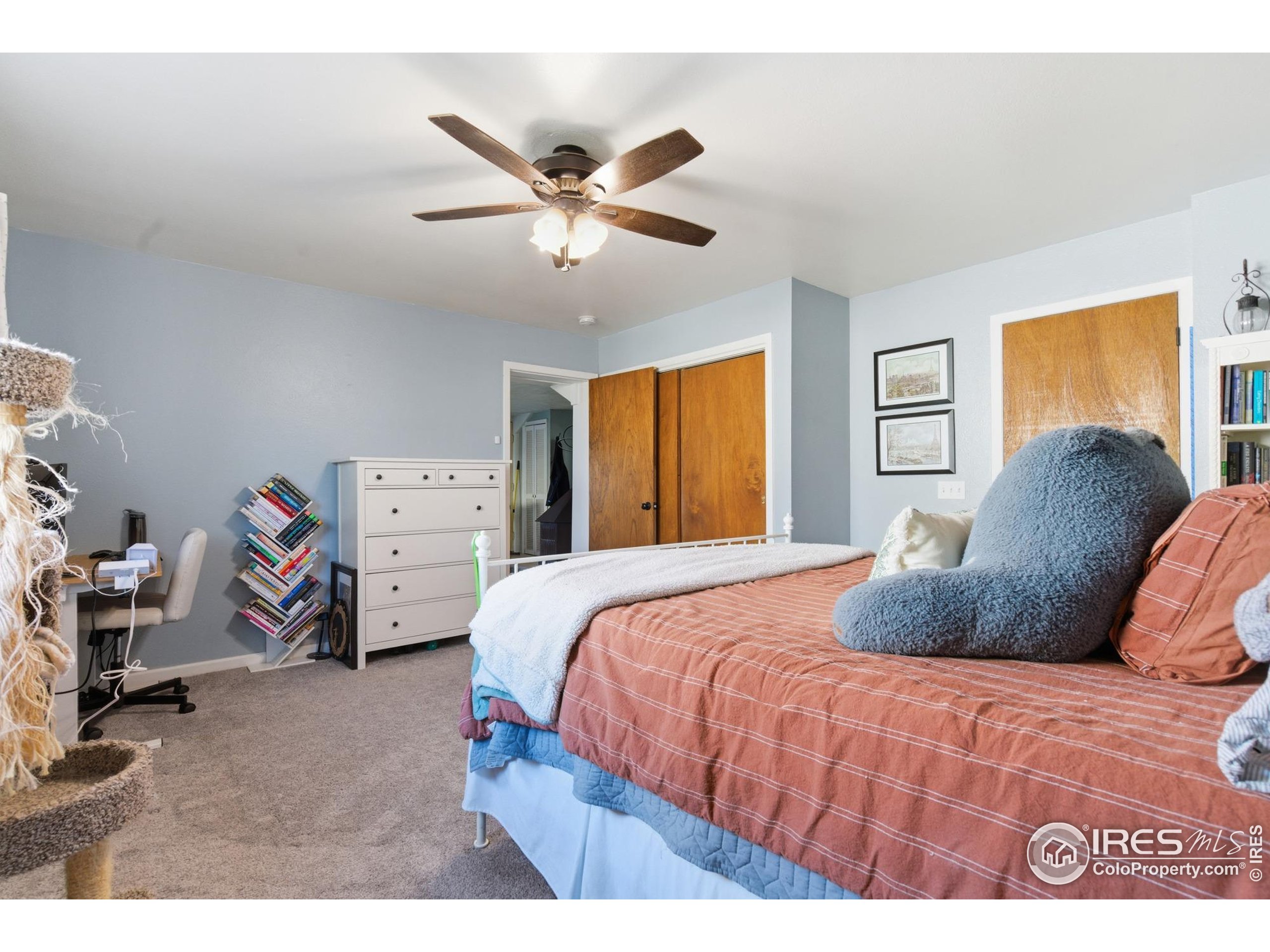 7905 3rd Street Wellington, CO 80549 - Photo 7 of 25 a bedroom with a bed and a chandelier