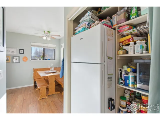 a room with refrigerator and wooden floor