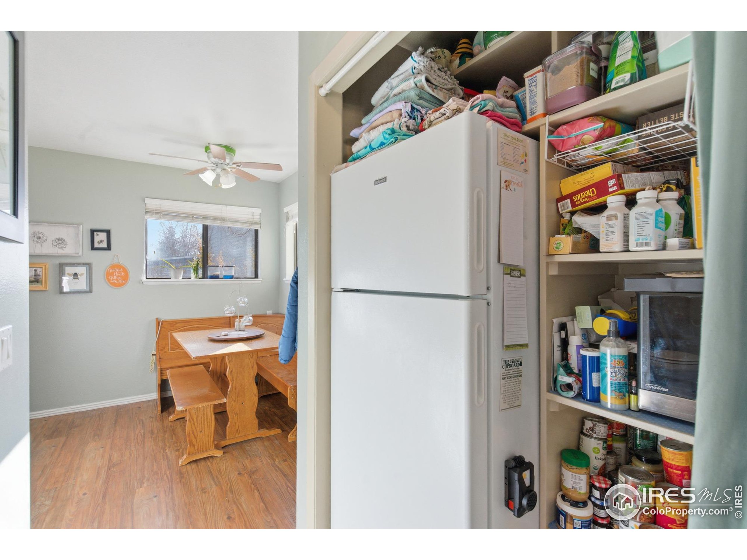 7905 3rd Street Wellington, CO 80549 - Photo 9 of 25 a room with refrigerator and wooden floor