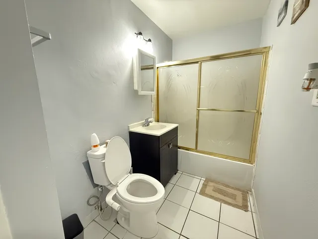a bathroom with a sink mirror vanity and toilet